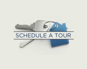 An image of keys with text that states schedule a tour.