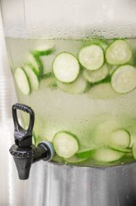 A drink dispenser with cucumber water.