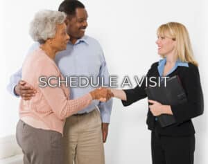 A photo of a senior couple shaking hands with a sales counselor that states Schedule A Visit.