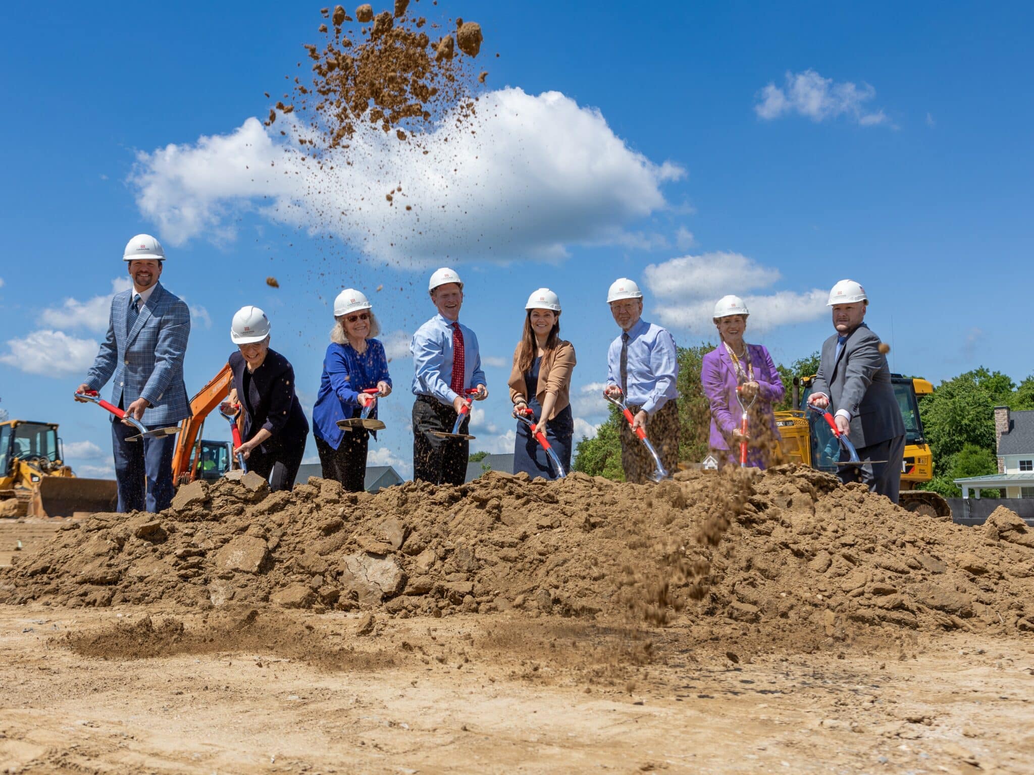 The participants dig in excitement as the expansion project groundbreaking begins coming to fruition.